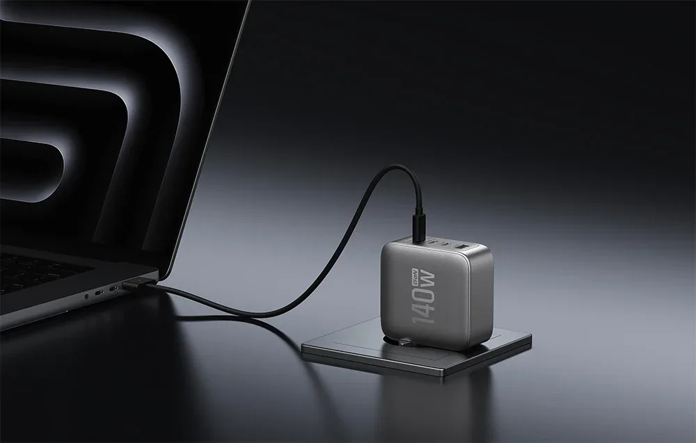 EcoFlow RAPID Pro 140W wall charger charging an open laptop