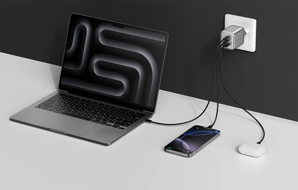 EcoFlow RAPID Pro 100W charger powering a laptop, smartphone, and TWS earbuds case