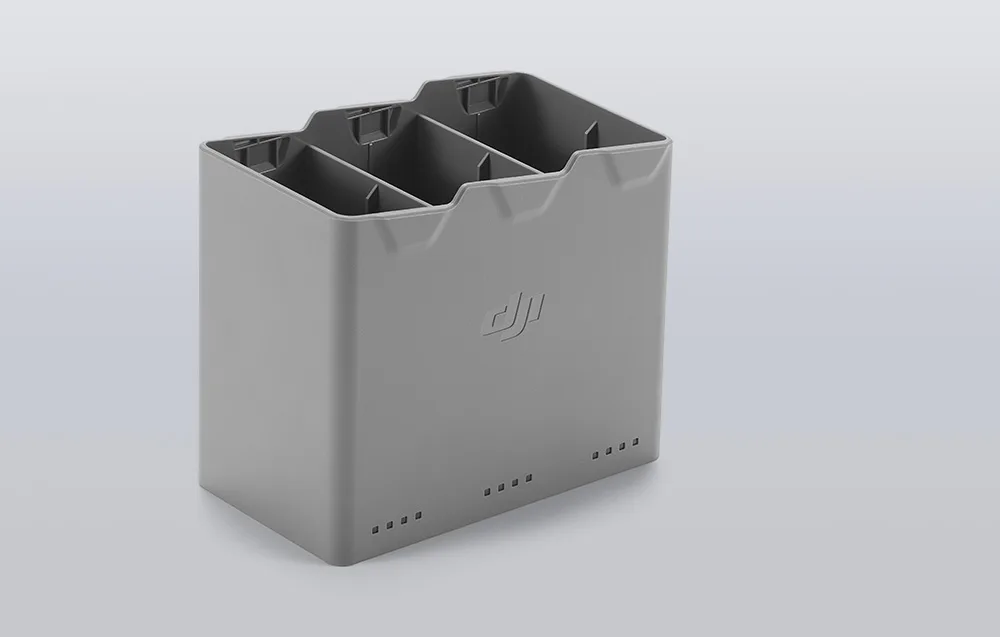 Сірий зарядний хаб DJI Mini 5 Pro з трьома відсіками та логотипом по центру