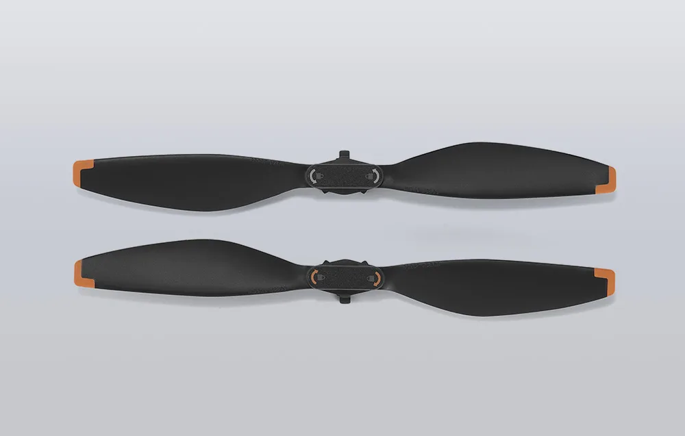Pair of DJI Mini 5 Pro drone propellers in black with orange accents