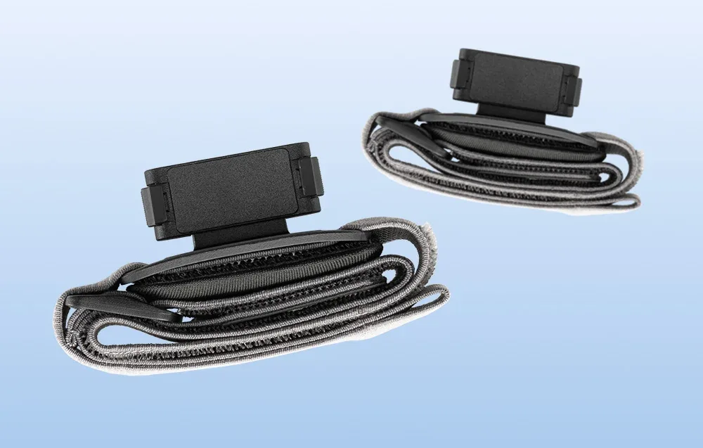 Two folded DJI Osmo Nano headbands with magnetic mounts arranged on a blue background