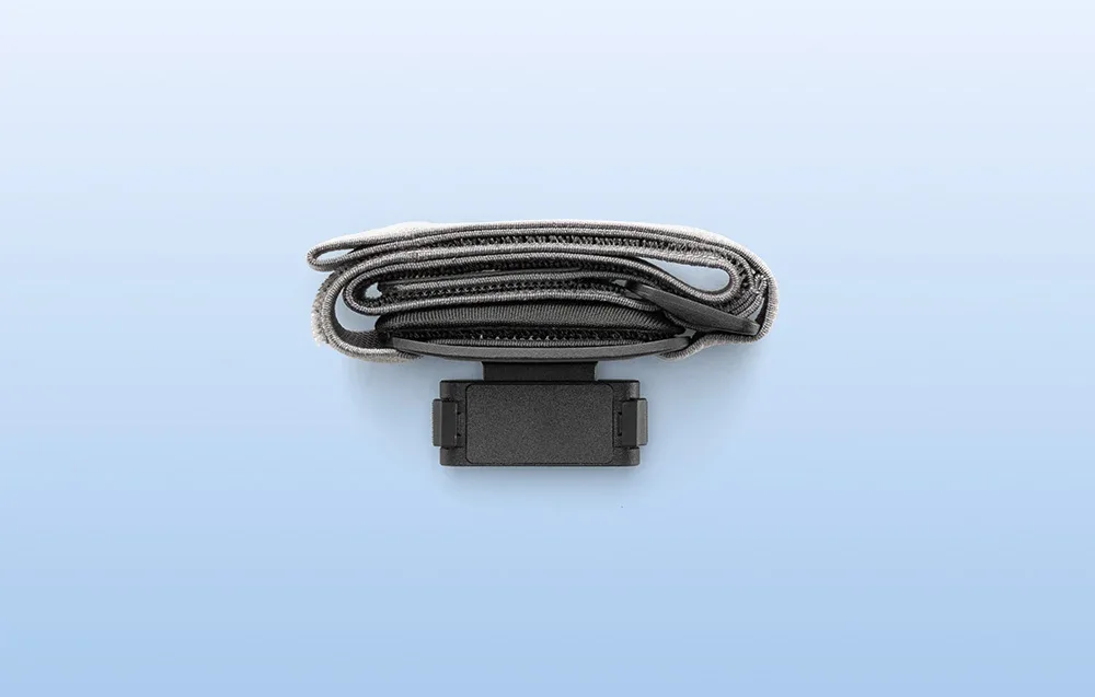 Folded DJI Osmo Nano headband with magnetic mount shown from above on a light background
