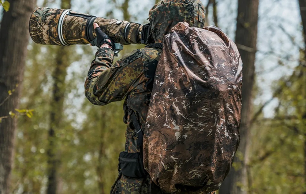 Photographer in camouflage using the PGYTECH OnePro ST backpack with camo rain cover in the forest