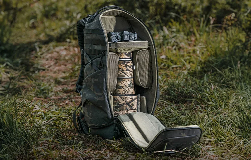 Open PGYTECH OnePro ST backpack showing interior compartments for camera gear and accessories