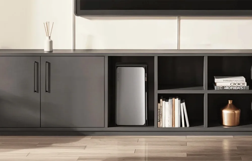 Silver EcoFlow STREAM AC energy storage unit placed inside an open dark gray cabinet niche with books and decorations