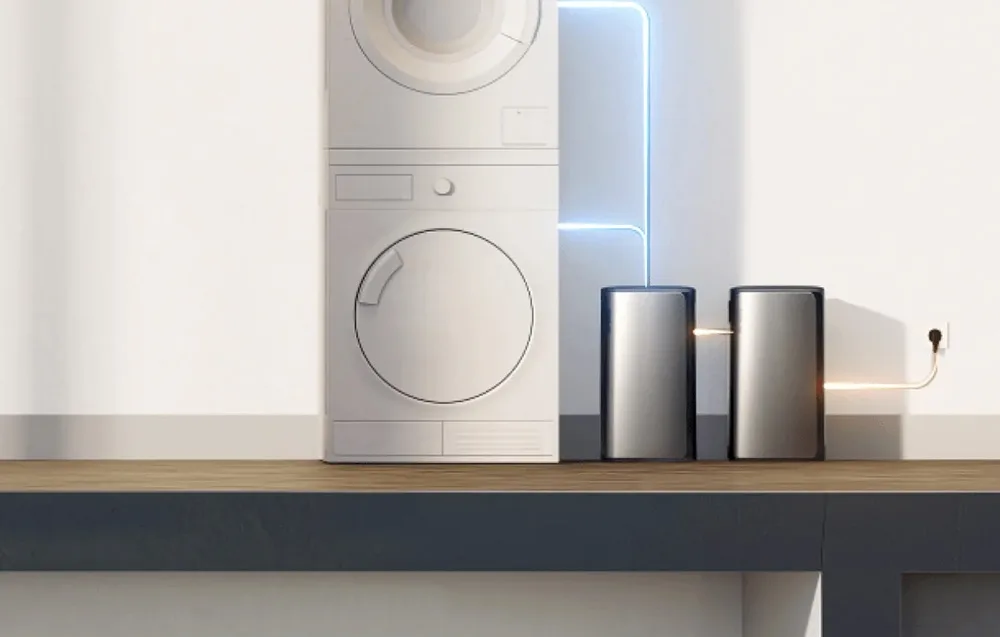 Two EcoFlow STREAM AC energy storage units placed next to a washer and dryer against a light wall