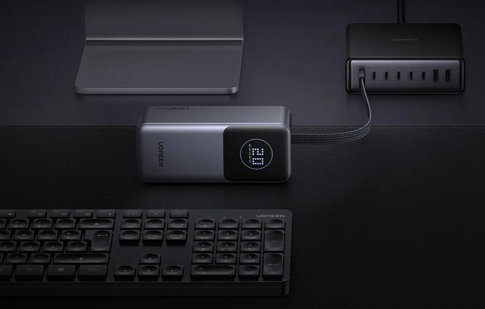 Ugreen PB723 power bank connected on a desk next to a keyboard