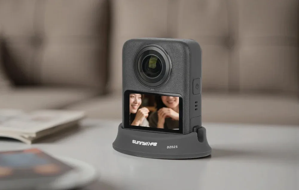 Kamera 360 stopni ustawione na czarnej podstawce na jasnym blacie