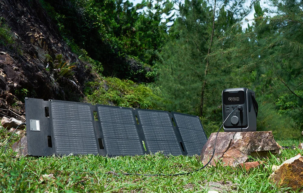 Solar panel connected to the EcoFlow TRAIL 300 DC portable power station standing on a rock in the forest