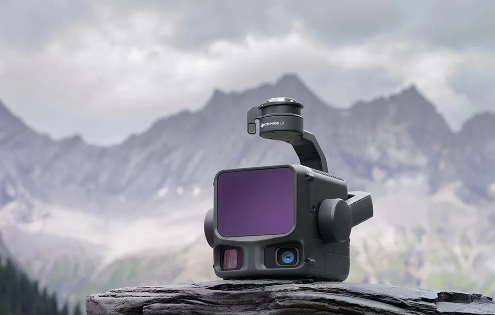 DJI Zenmuse L3 camera placed on a rock with mountain peaks in the background