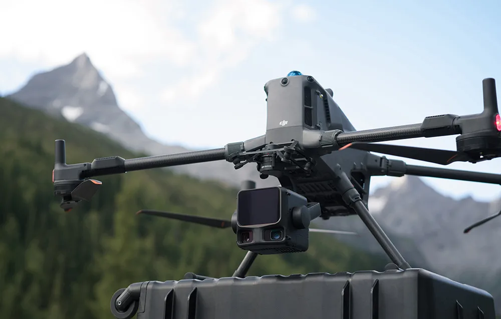 DJI Matrice 400 drone with Zenmuse L3 camera on a transport case in the mountains