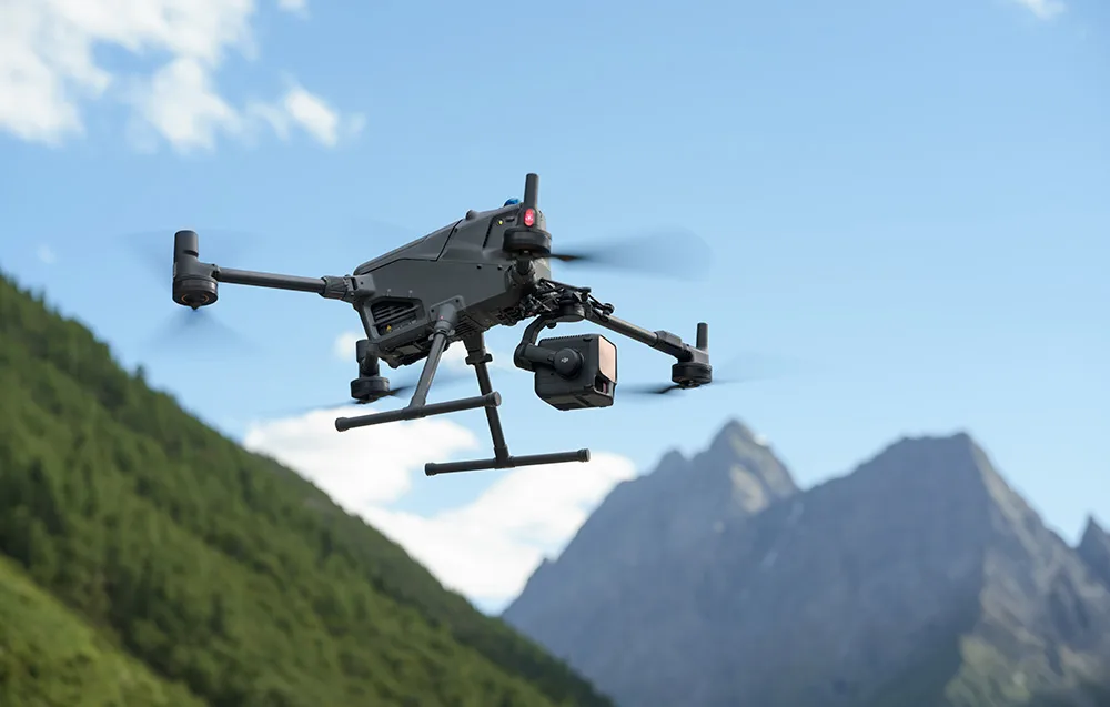 Drone with DJI Zenmuse L3 camera flying over mountain terrain