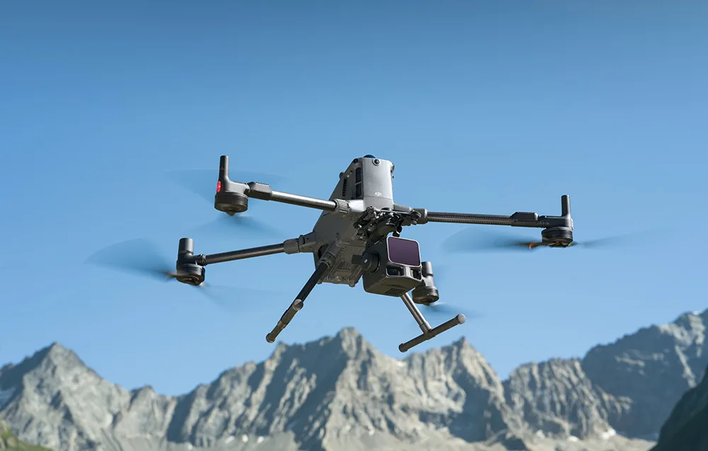 Drone with Zenmuse L3 camera flying over rocky mountain peaks