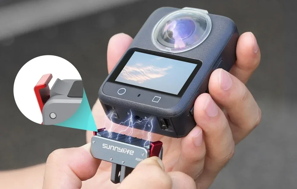 Hand holding a 360 camera mounted on the SunnyLife magnetic adapter