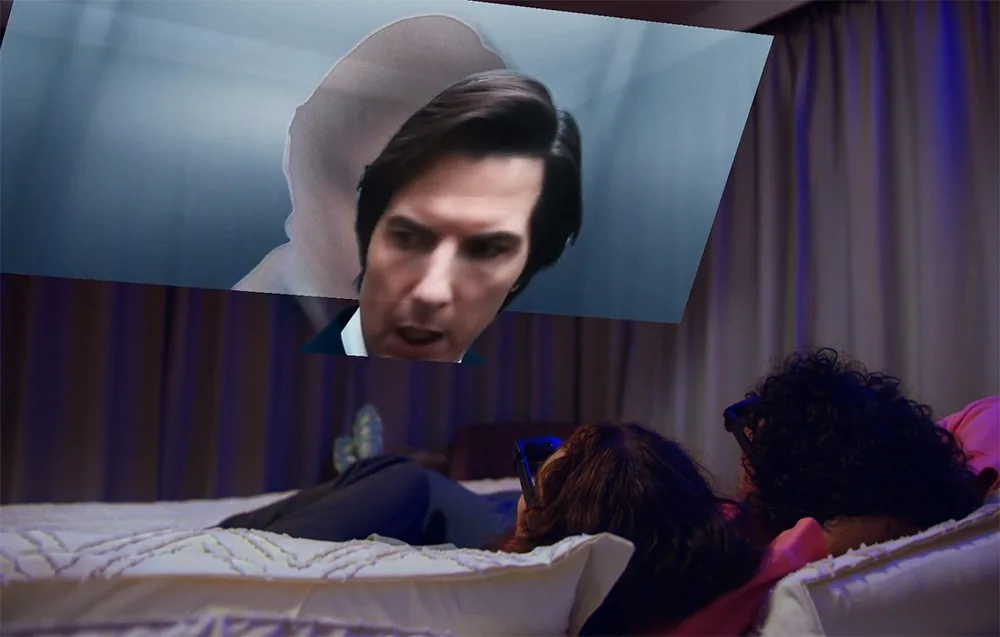 Two people relaxing on a bed while watching a floating virtual image with VITURE XR Luma glasses