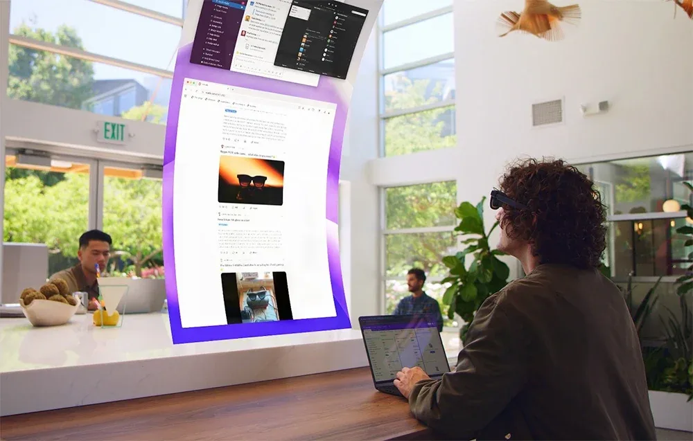 Person using VITURE XR Luma Ultra glasses with a laptop in a bright room