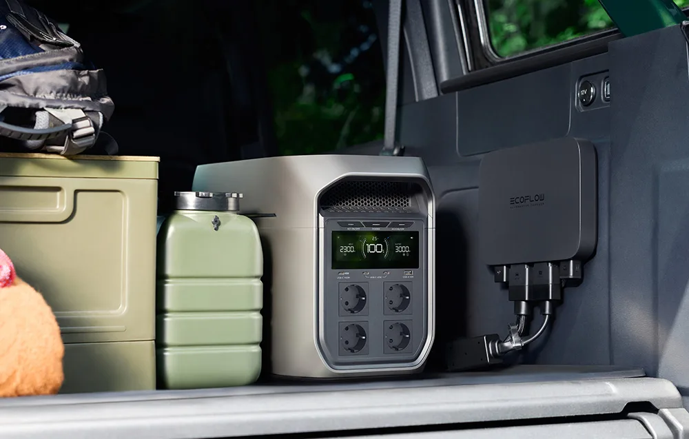 EcoFlow power station in the trunk of a camper van next to fuel cans and travel gear.