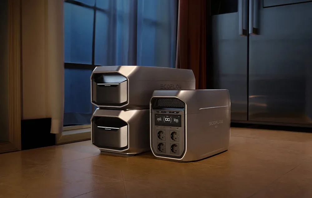 EcoFlow DELTA 3 Max Plus power station with two extra batteries placed on the floor near a large window.