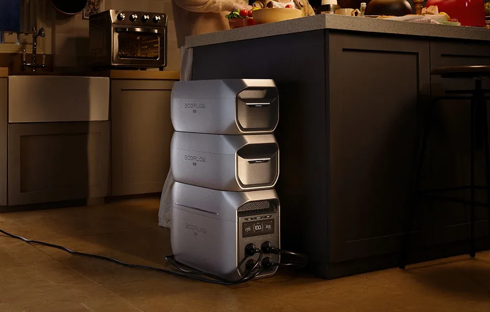 Three EcoFlow power modules stacked vertically in a kitchen under the island countertop.