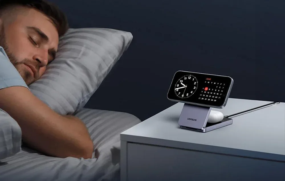 UGREEN W706 magnetic wireless charger with smartphone and TWS earbuds on a bedside table