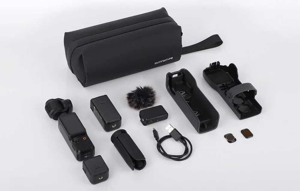 Black Sunnylife organizer bag with camera accessories, microphone, and cables on a gray background