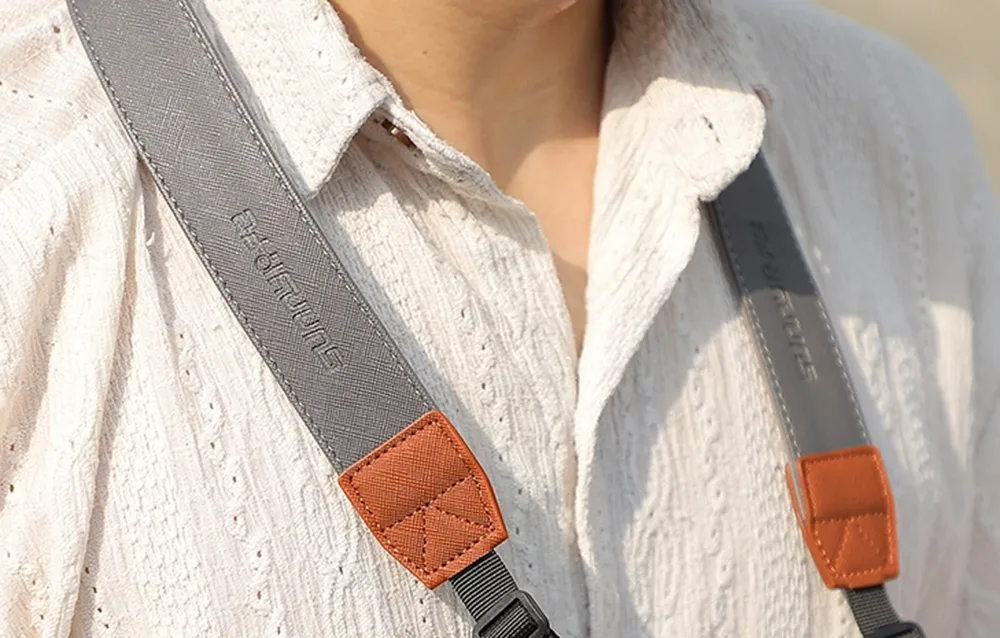 Close-up of Sunnylife controller strap details with gray and orange elements