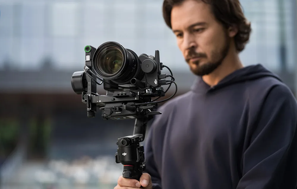 Close-up of a filmmaker holding a professional camera on a gimbal