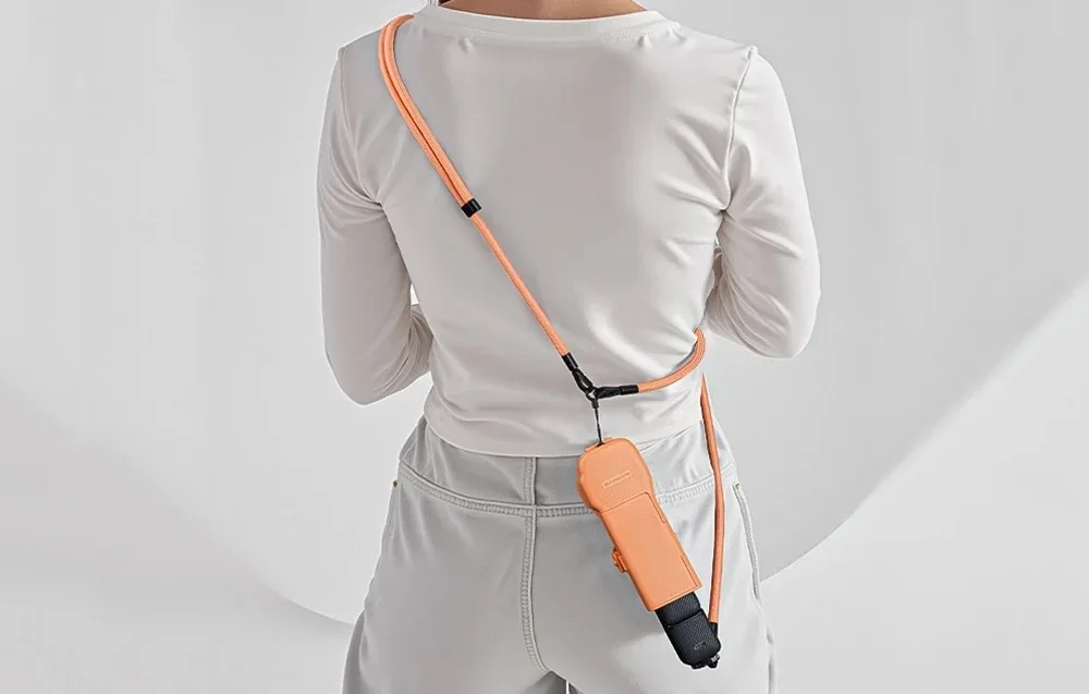 Back view of a woman wearing the Sunnylife neck strap with a camera attached