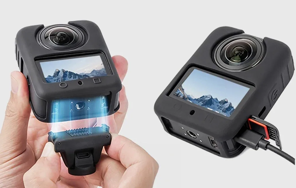 Two DJI Osmo 360 cameras in black silicone covers, one mounted and one connected for charging