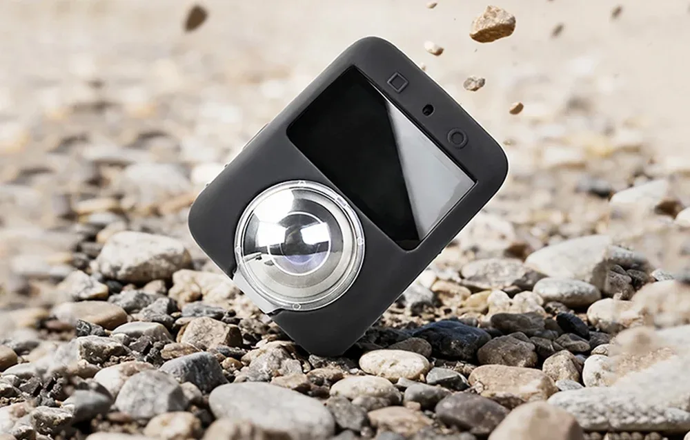 DJI Osmo 360 in a black Sunnylife silicone cover with lens protection during outdoor impact test on stones