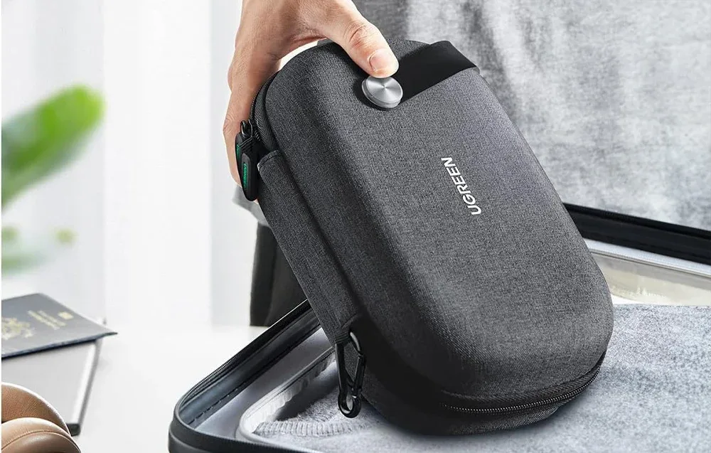 UGREEN LP152 travel organizer being packed into a suitcase