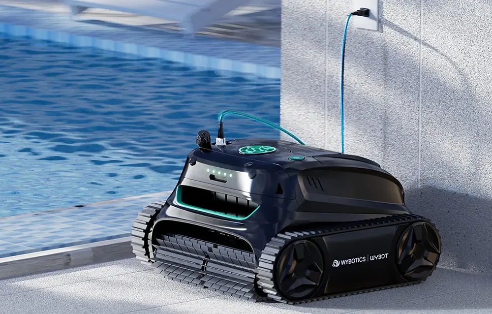 Wybot S2 Solar pool cleaning robot charging from a power outlet near the pool