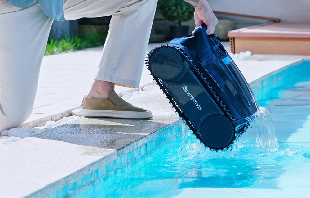 Person removing the WYBOT robot from the pool