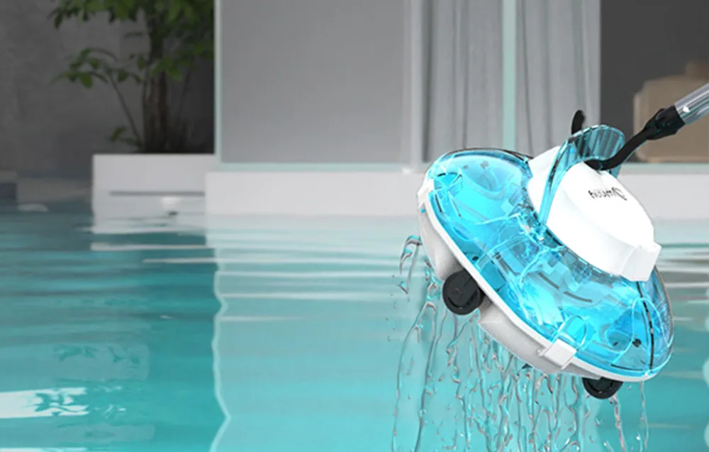 White cordless pool cleaning robot with a transparent turquoise dome being lifted out of the pool at the edge with water dripping off it
