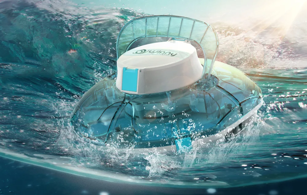 White cordless pool cleaning robot with a transparent dome emerging from the water with splashes around it