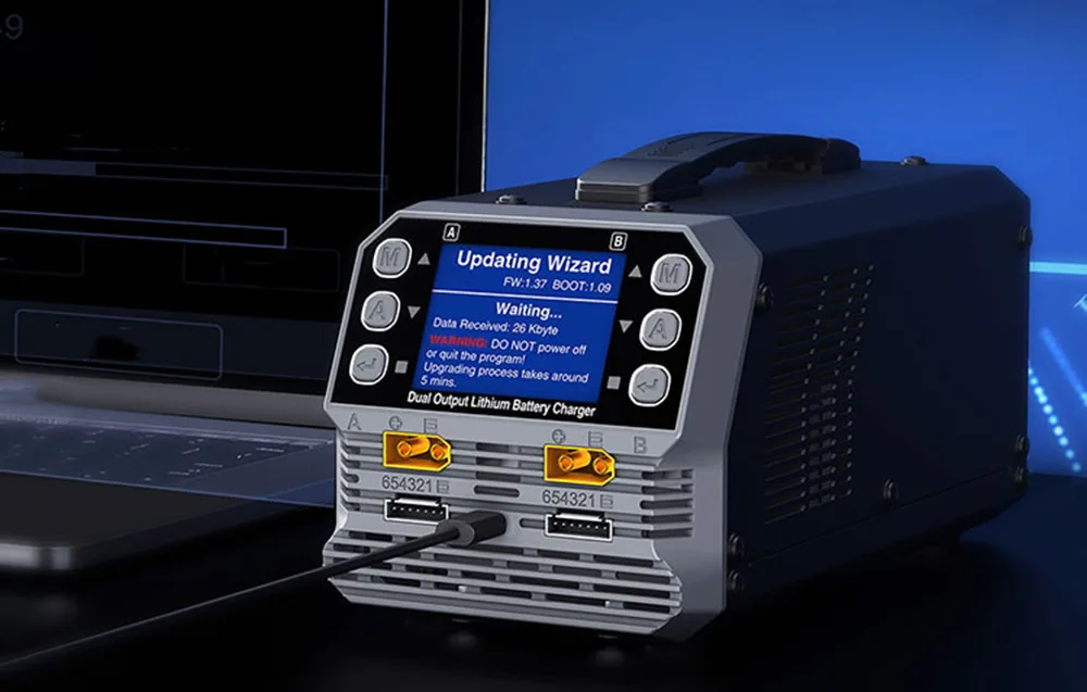 SkyRC PC1080neo dual-channel lithium battery charger with monitor in the background