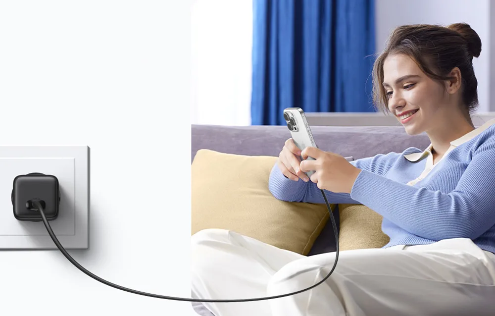 Woman using a smartphone connected to the Ugreen X518 charger