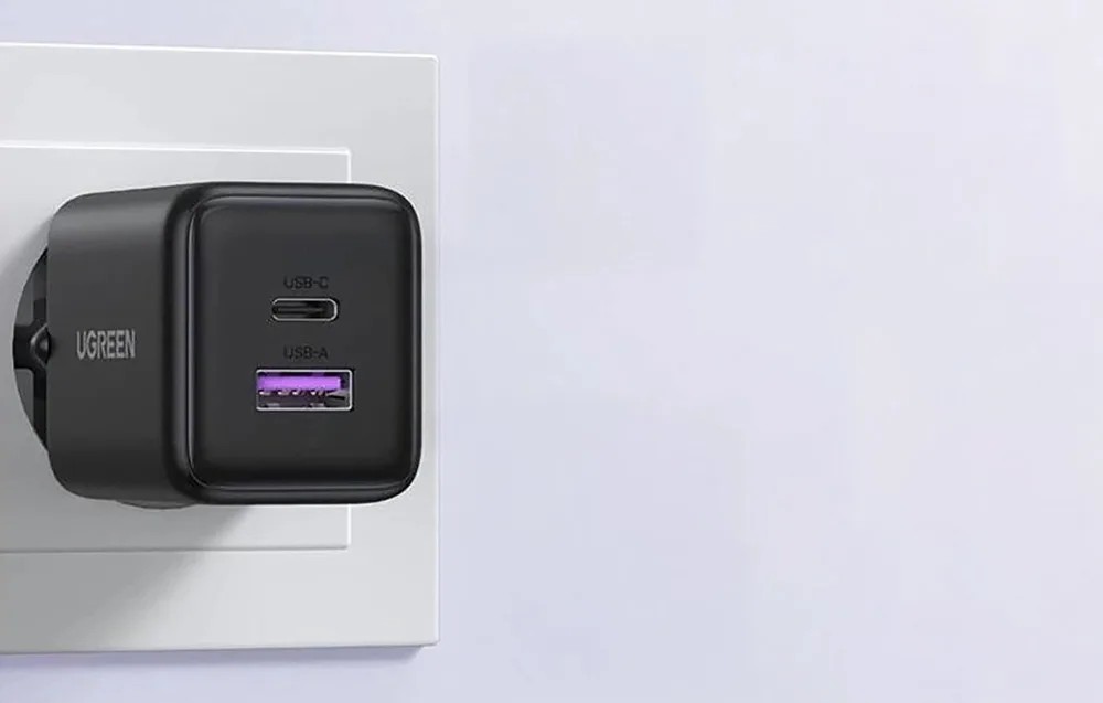 Ugreen X516 black wall charger plugged into a wall outlet