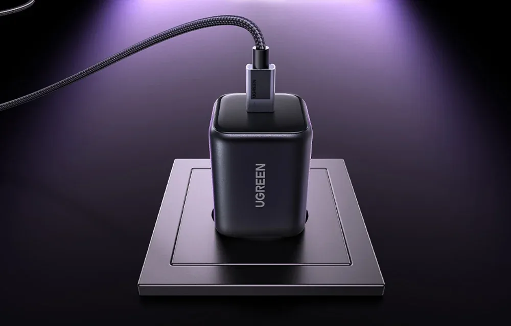 UGREEN X524 black USB-C charger plugged into a wall socket with USB-C cable connected