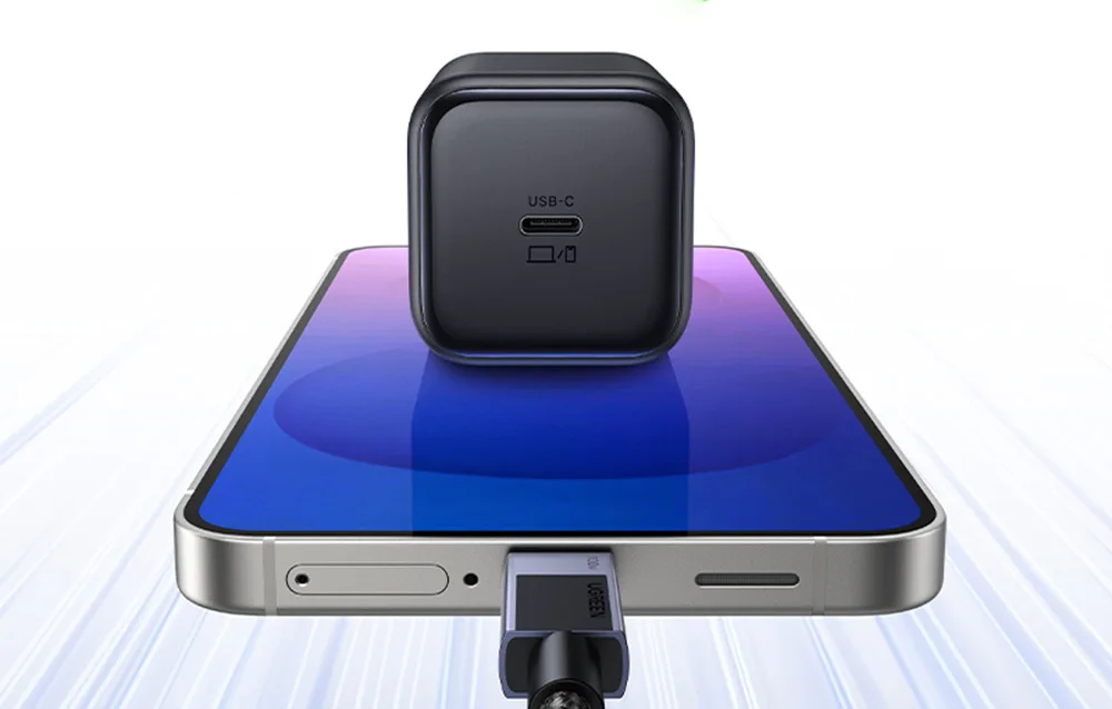 UGREEN X524 black USB-C charger placed on a smartphone with USB-C cable connected