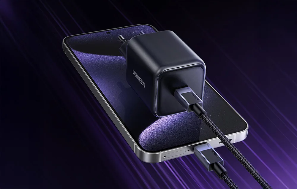 UGREEN black wall charger with connected USB-C cable placed on a smartphone.