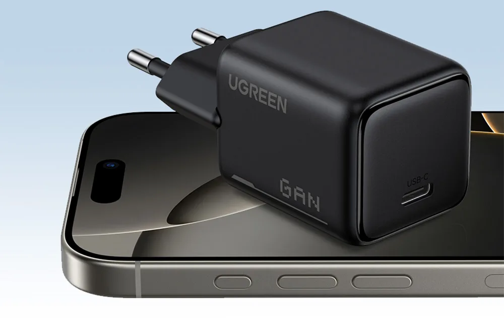 Black UGREEN GaN charger with USB-C port placed on a smartphone