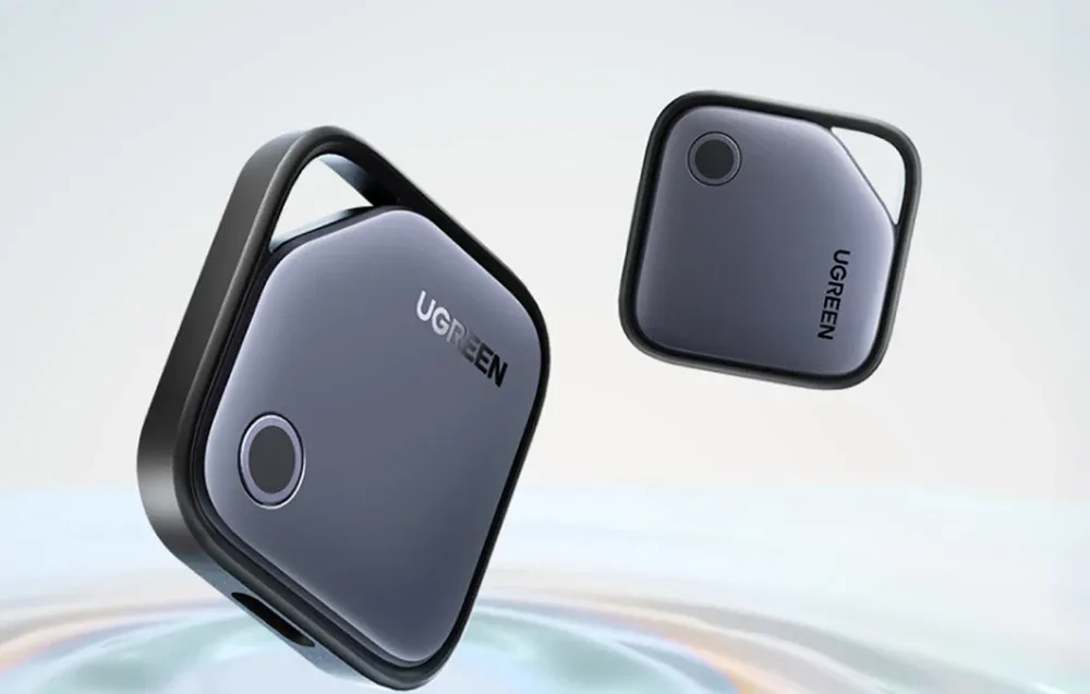 Two black UGREEN Smart Finder CM919 v2 trackers floating in the air.