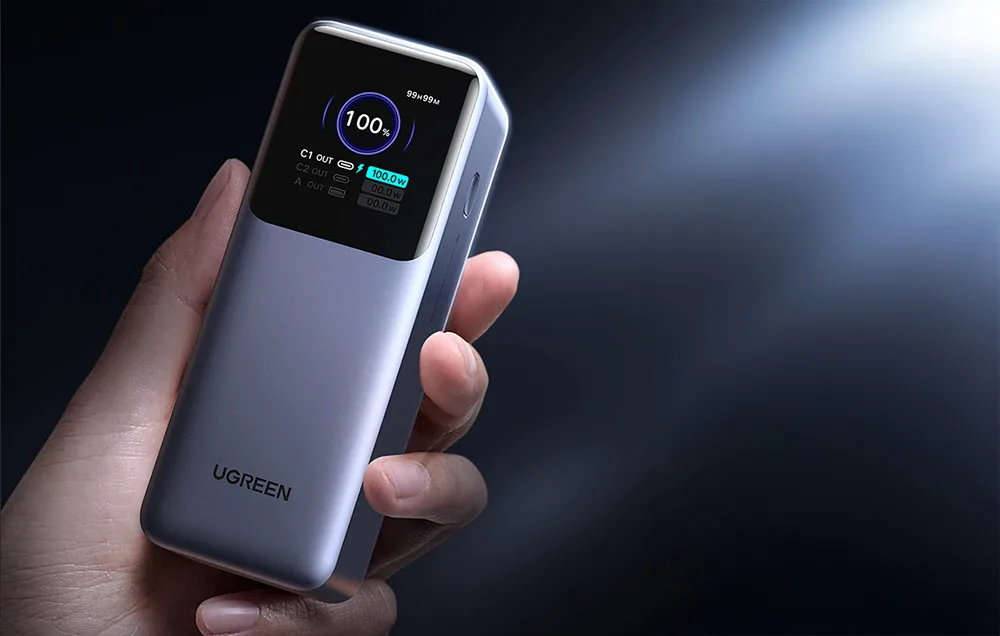 Close-up of Ugreen PB726 power bank display showing 100 percent battery level