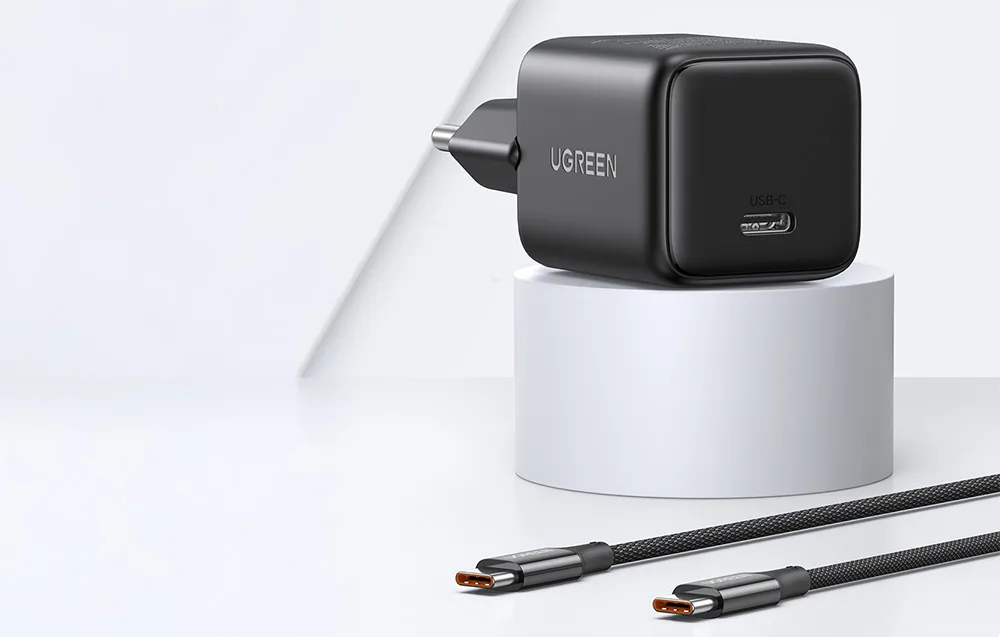 UGREEN X513 black USB-C wall charger with braided USB-C cable on a white display stand