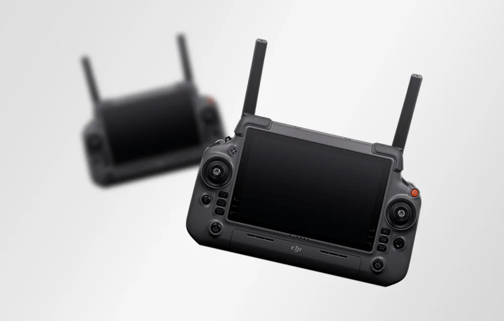Two DJI RC Plus 2 controllers with antennas and large displays on a bright background