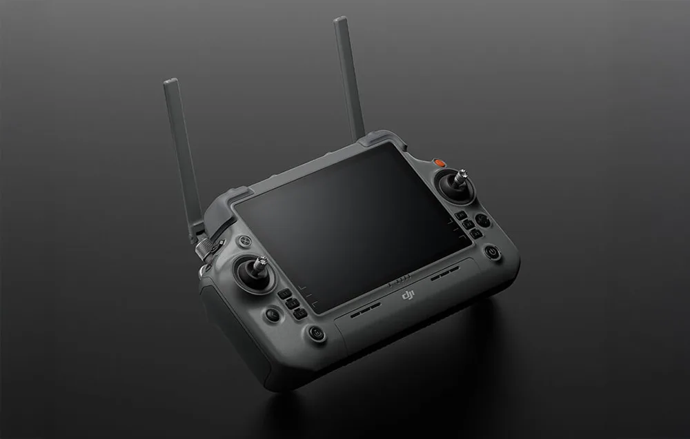 Graphite DJI RC Plus 2 controller with dual antennas, control sticks, and touchscreen display on a dark background