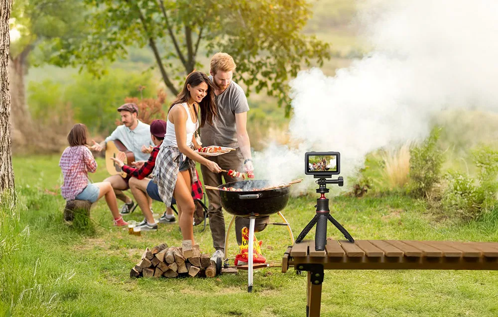 DJI camera on a tripod with magnetic adapter recording a family barbecue in the garden
