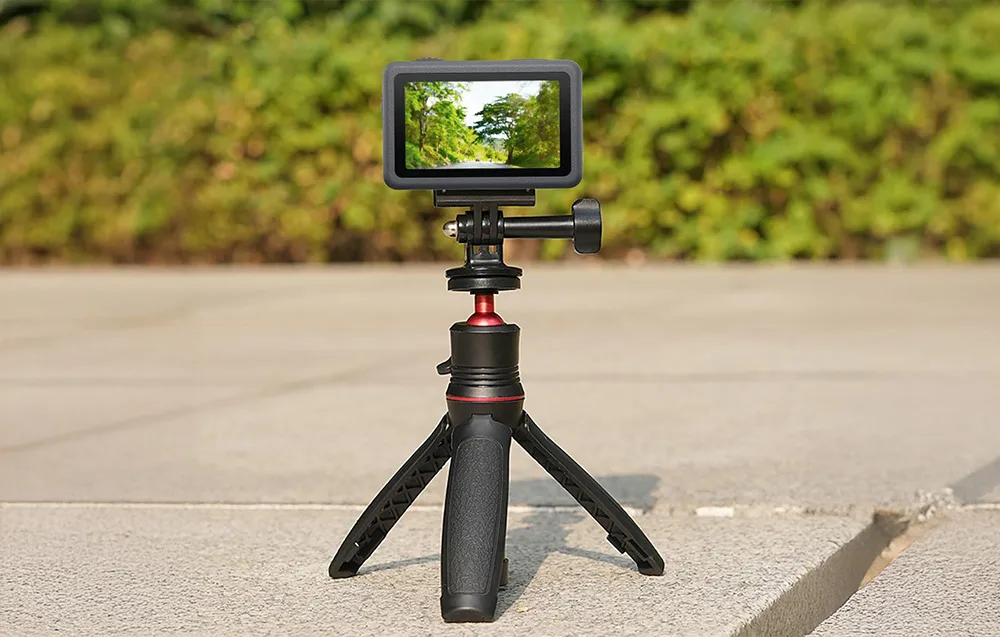 DJI camera with magnetic adapter mounted on a low tripod on a concrete surface