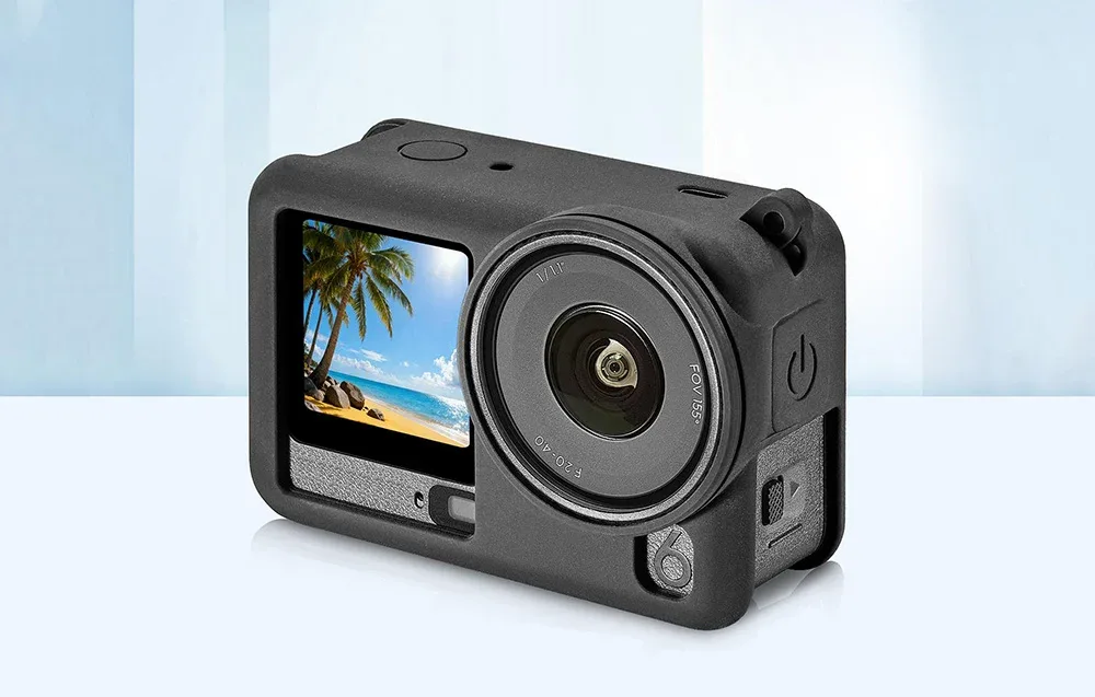 DJI Osmo Action 6 in a silicone protective case with visible screen and lens, showing a beach with palm trees
